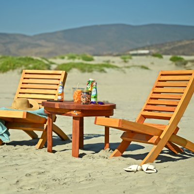 Round Solid Wood Side Table (Options: 28 3/4", California Redwood, Rounded Apron, 20 inches tall, Transparent Premium Sealant, Seamless Tabletop by Custom Request). Photo Also Shows 2 Portable Beach Chairs.