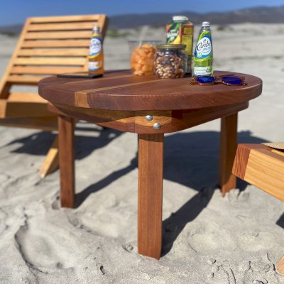 Round Solid Wood Side Table (Options: 28 3/4", California Redwood, Rounded Apron, 20 inches tall, Transparent Premium Sealant, Seamless Tabletop by Custom Request). Photo Also Shows 2 Portable Beach Chairs.