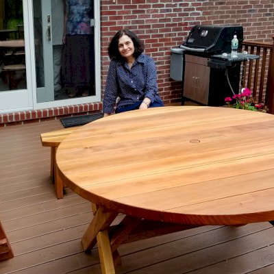 Round Wood Picnic Table with Wheels (Options: 5' diameter, Unattached Benches, Redwood, Round Picnic Benches, Standard Tabletop, No Lazy Susan, 1 5/8" Umbrella Hole & Plug, Transparent Premium Sealant). Photo Courtesy of A. Adler of Hempstead, New York.