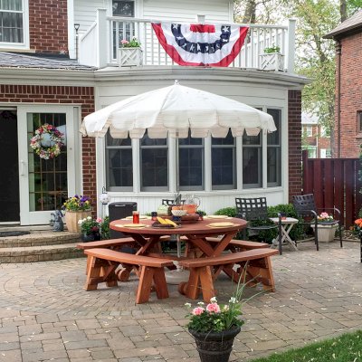 Round Wood Picnic Table with Wheels (Options: 5.5' Diameter, Unattached Benches, Mature Redwood, Round Picnic Benches, Standard Tabletop, 20" Lazy Susan, Umbrella Hole & Plug, Transparent Premium Sealant). Photo Courtesy of Dorothy and Sam Cusmano of Grosse Pointe Park, Michigan.