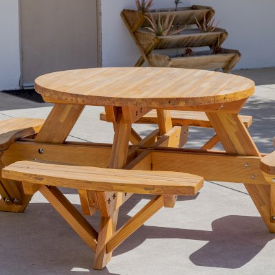 Round Wooden Picnic Table (Attached Benches) (Options: 4' Diameter, Attached Benches, Mosaic Douglas-Fir, Standard Tabletop, No Lazy Susan, No Umbrella Hole, Transparent Premium Sealant). Photo courtesy of Vanguard University [55 Fair Dr, Costa Mesa, CA].