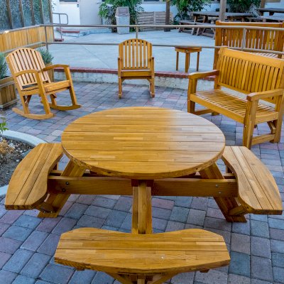 Round Wooden Picnic Table (Attached Benches) (Options: 4' Diameter, Attached Benches, Mosaic Douglas-Fir, Standard Tabletop, No Lazy Susan, No Umbrella Hole, Transparent Premium Sealant). Photo courtesy of Vanguard University [55 Fair Dr, Costa Mesa, CA].