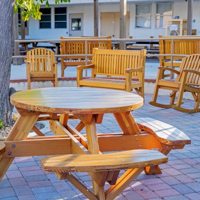 Round Wooden Picnic Table (Attached Benches) (Options: 4' Diameter, Attached Benches, Mosaic Douglas-Fir, Standard Tabletop, No Lazy Susan, No Umbrella Hole, Transparent Premium Sealant). Photo courtesy of Vanguard University [55 Fair Dr, Costa Mesa, CA].