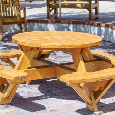 Round Wooden Picnic Table (Attached Benches) (Options: 4' Diameter, Attached Benches, Mosaic Douglas-Fir, Standard Tabletop, No Lazy Susan, No Umbrella Hole, Transparent Premium Sealant). Photo courtesy of Vanguard University [55 Fair Dr, Costa Mesa, CA].