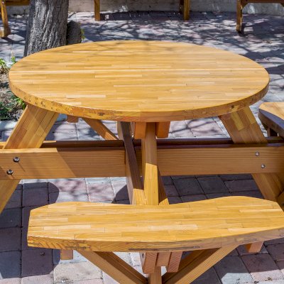 Round Wooden Picnic Table (Attached Benches) (Options: 4' Diameter, Attached Benches, Mosaic Douglas-Fir, Standard Tabletop, No Lazy Susan, No Umbrella Hole, Transparent Premium Sealant). Photo courtesy of Vanguard University [55 Fair Dr, Costa Mesa, CA].