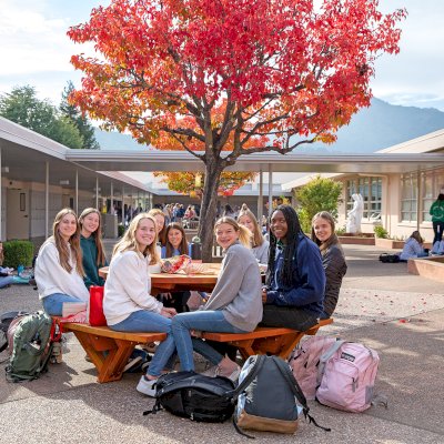 Round Wooden Picnic Tables (Attached Benches) (Options: 5' Diameter, Attached Benches, Douglas-fir, Standard Tabletop, No Lazy Susan, No Umbrella Hole, Transparent Premium Sealant). Photo Courtesy of Marin Catholic High School in Kentfield, CA.