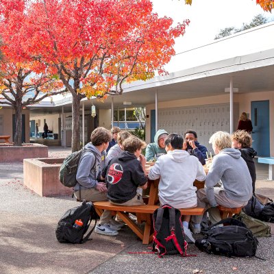Round Wooden Picnic Tables (Attached Benches) (Options: 5' Diameter, Attached Benches, Douglas-fir, Standard Tabletop, No Lazy Susan, No Umbrella Hole, Transparent Premium Sealant). Photo Courtesy of Marin Catholic High School in Kentfield, CA.