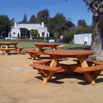 Round Wooden Picnic Tables (Attached Benches) (Options: 5' Diameter, Attached Benches, California Redwood, Standard Tabletop, No Lazy Susan, Umbrella Hole & Plug, Transparent Premium Sealant). 