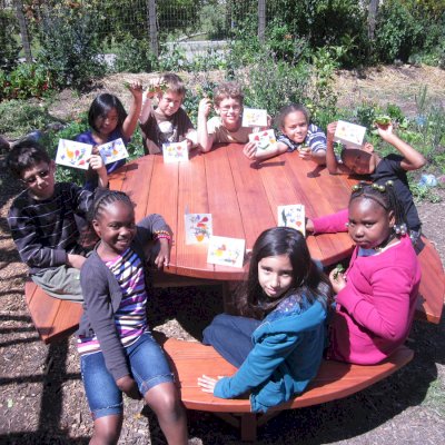 Round Wooden Picnic Tables (Attached Benches) (Options: 5' Diameter, Attached Benches, California Redwood, Standard Tabletop, No Lazy Susan, No Umbrella Hole, Transparent Premium Sealant). Photo courtesy of Rivka M. of Berkeley, CA. 