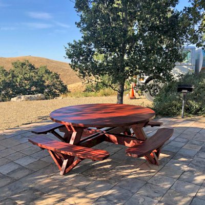 Round Wooden Picnic Tables (Attached Benches) (Options: 6' Diameter, Attached Benches, Mature Redwood, Standard Tabletop, No Lazy Susan, 1 5/8" Diameter Umbrella Hole, Transparent Premium Sealant). Photo Courtesy of W. Fry of Lafayette, California.