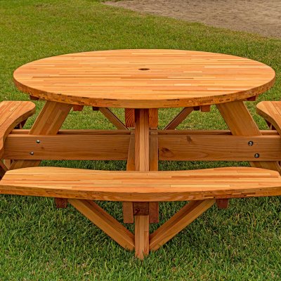 Round Wooden Picnic Table (Attached Benches) (Options: 5' Diameter, Attached Benches, Mosaic Douglas-Fir, Standard Tabletop, No Lazy Susan, 2" Umbrella Hole, Transparent Premium Sealant). Photo courtesy of El Estero Beach Resort in Ensenada, Mexico.
