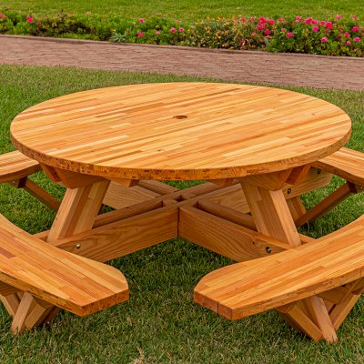 Round Wooden Picnic Table (Attached Benches) (Options: 5' Diameter, Attached Benches, Mosaic Douglas-Fir, Standard Tabletop, No Lazy Susan, 2" Umbrella Hole, Transparent Premium Sealant). Photo courtesy of El Estero Beach Resort in Ensenada, Mexico.