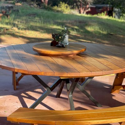 Round Wooden Picnic Tables (Detached Benches) with Custom Steel Pedestal Leg Design (Options: 7' diameter, California Redwood, Arc Picnic Bench, Standard Tabletop, with Lazy Susan, No Umbrella Hole, Transparent Premium Sealant). Photo Courtesy of Alex P. of Lower Lake, CA.