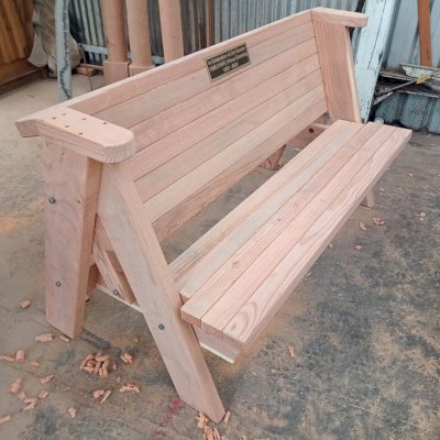 Rustic Redwood Bench (Options: 5 ft, Mature Redwood, No Cushion, No Engraving - Plaque made locally and shipped to us for inlaying and installation). Photo Taken in Production. 