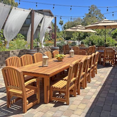 San Francisco Redwood Patio Table (Options: 12' L, 46" W Tabletop, Chairs, Mosaic Eco-Wood, 12 Chairs, Luna Chair Design, 2 Armchairs & Side Chairs, No Cushions, Standard Tabletop, Slightly Rounded Corners, No Umbrella Hole, Transparent Premium Sealant). Photo Also Shows 2 Round Patio Table Sets in Background. Photo Courtesy of J. Newman of Carmel Valley, CA.