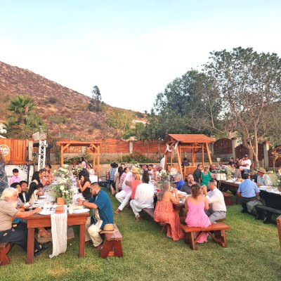 Photo Shows Several Forever Redwood Tables, a Small Garden Pergola and a Dustin's Face to Face Glider.