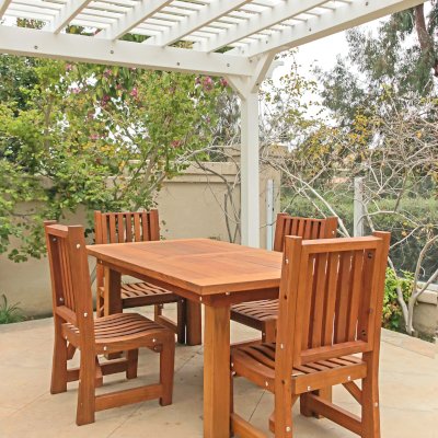 San Francisco Redwood Patio Table (Options: 6' L, 40 1/4" W Tabletop, Chairs, Mature Redwood, 4 Chairs, Ruth Chair Design, All Side Chairs, No Cushions, Old Country Tabletop, Standard, Squared Corners, No Umbrella Hole, Transparent Premium Sealant). Table Set Under a Traditional Garden Pergola in White Finish. Photo Courtesy of J. Schulte of Laguna Niguel, CA.