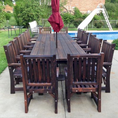 San Francisco Redwood Patio Table (Options: 7' L, 46" W Tabletop, Chairs, Mature Redwood, 8 Chairs, Ruth Chair Design, All Arm Chairs, No Cushions, Standard Tabletop, Slightly Rounded Corners, Umbrella Hole, Coffee-Stain Premium Sealant). Photo Courtesy of Andy D. of Indianapolis Indiana.