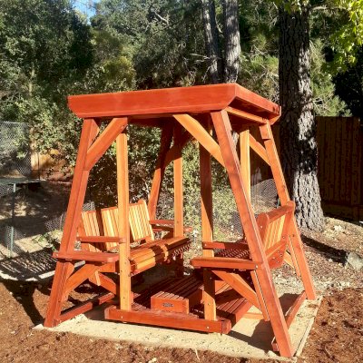 Santa Rosa Face to Face Gliders (Adult Size, Redwood, With Beverage Armrests, Kid's Platform, No Engraving, Transparent Premium Sealant). Photo Courtesy of Susan Peters of Novato, CA.