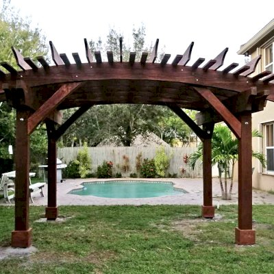 Sebastopol Pergolas (Options: 14' L x 16' Arc W, California Redwood, 4-Post Anchor Kit for High-Wind, No Ceiling Fan Base, 9' H Posts, Coffee-Stain Premium Sealant). Photo Courtesy of T. Green of Boynton Beach, Florida.