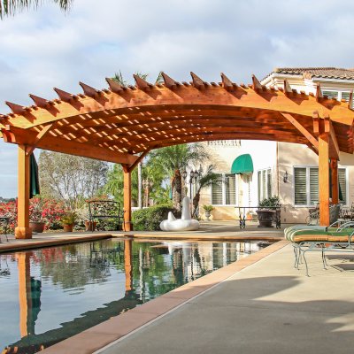 Sebastopol Pergolas (Options: 26' L x 24' Arc W, Mature Redwood, 4-Post Anchor Kit for High-Wind, Transparent Premium Sealant). Photo Courtesy of Ms. Diane Williams of Encinitas, CA. Photo shows extra large timber custom design with 8x8 posts and 2x10 arches, 26 ft long.