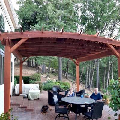 Custom Sebastopol Pergolas (Options: 20' L x 18' Arc W, California Redwood, 4-Post Anchor Kit for Concrete, with Lattice Panels by Custom Request, No Ceiling Fan Base, 10' H Posts, Transparent Premium Sealant). Photo Courtesy of E. Greenwood of Nevada City, California.