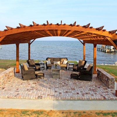 Sebastopol Pergolas (Options: 32' L x 24' Arc W, California Redwood, 6-Post Anchor Kit for High-Wind, No Ceiling Fan Base, Transparent Premium Sealant). Photo Courtesy of J. Graves of Santa Rosa Beach, Florida.