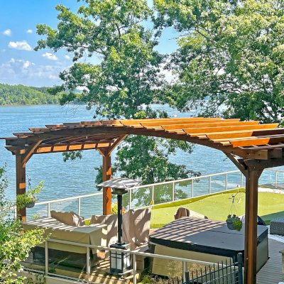 Custom Sebastopol Pergola (Options: 22' L x 12' Arc W, California Redwood, 4-Post Anchor Kit for Concrete, 2 Ceiling Fan Bases, 10.5' H Posts, Viking End Cut for Supports & Rafters, Transparent Premium Sealant). Photo Courtesy of K. Johnson of Gallatin, TN.