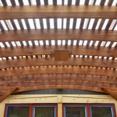 Sebastopol Pergolas (Options: 21' L x 19' Arc W, Mature Redwood, 4-Post Anchor Kit for High-Wind, with a Ceiling Fan Base, Transparent Premium Sealant). Photo Courtesy of R. Erickson of Sawyer, Michigan.