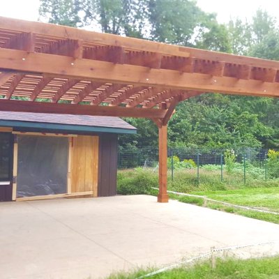 Sebastopol Pergolas (Options: 21' L x 19' Arc W, Mature Redwood, 4-Post Anchor Kit for High-Wind, with a Ceiling Fan Base, Transparent Premium Sealant). Photo Courtesy of R. Erickson of Sawyer, Michigan.