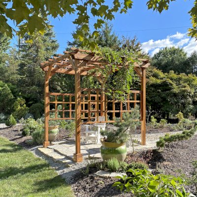 Small Garden Pergola Kit (Options: 9' L x 9' W, Custom Privacy Panels on 2 Sides, Mosaic Redwood, 9 ft Post Height, 6" Overhangs, 4-Post Anchor Kit for Concrete, No Curtain Rods, No Decorative Trims, Transparent Premium Sealant). Photo Courtesy of B. Egbert of Dayton, OH.