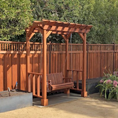 Small Garden Pergola Kit (Options: 8' L x 5' W, Custom Railings on 2 Sides, Mature Redwood, 9 ft Post Height, 4-Post Anchor Kit for Concrete, No Curtain Rods, No Decorative Trims, Transparent Premium Sealant) with a Garden Bench Swing. Photo Courtesy of B. Marinaro of Palo Alto, CA.