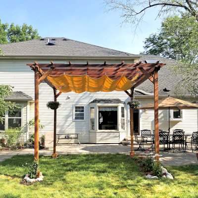 Small Garden Pergola Kit (Options: 12' L x 12' W, No Privacy Panels, California Redwood, 9.5' Post height, 4-Post Anchor Kit for High-Wind, No Curtain Rods, No Decorative Trims,  Transparent Premium Sealant). Custom Canopy purchased form Infinity Canopy. Photo Courtesy of J. Minniti of Lisle, Illinois.