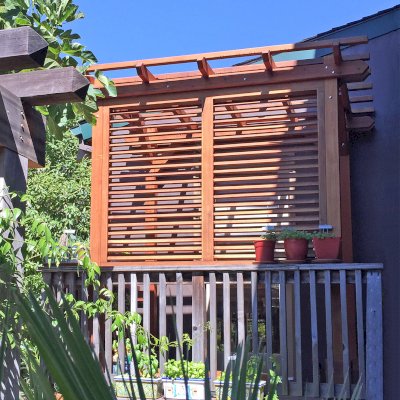Small Garden Pergola Kit (Options: 8' L x 5' W, with Wall Panel Louver Style, Mature Redwood, No Rain Guard, 8 ft Post Height, No Electrical Wiring Kit, No Post Decorative Trim, No Anchor Kit, No Curtain Rods, 1 Louver Privacy Panel Style Full Height, No Retractable Shade Canopy, Transparent Premium Sealant). Custom End Cuts, Photo Courtesy of J. Siino of Kirkland, WA.