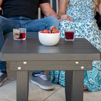 Square Side Table (Options: 23" Size, Mature Redwood, Rounded Corners, 18" H, Black Stain Premium Sealant) with a Massive Rocking Bench.
