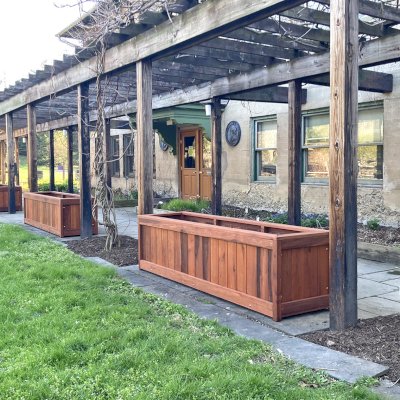 Sonoma Planters (Options: 96" L, 24" W x 24" H, Old-Growth Redwood, No Seating Ledge, 1-inch feet, No Trellis, Interior and Exterior of Box with Sealant (No Growing Vegetables), Transparent Premium Sealant). Photo Courtesy of E. Detrik of Ithaca, New York.