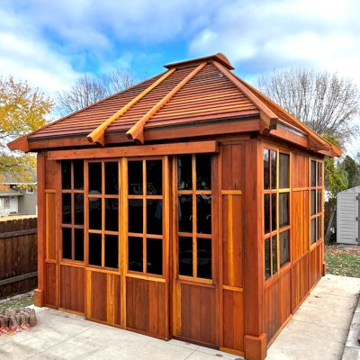 Custom Spa Gazebo Kit (Options: 12' L, 12' W, California Redwood, Combination of Fixed and Sliding Windows, 2' x 4' Skylight, 30" H Siding Below Windows, Vertical Siding, Japanese Doors with Screens, Custom Pitch, Shiplap Roof, No Flooring, Transparent Premium Sealant). Photo Courtesy of A. Calatayud of Savage, MN.