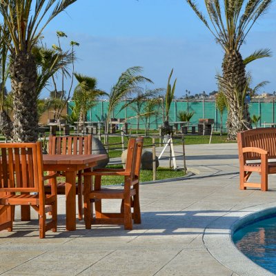 Square Patio Tables (Options: 4', 4 Chairs, Old-Growth Redwood, Ruth Style Chairs, Armchairs Only, No Cushions, Standard Tabletop, Squared Corners, Umbrella Hole, Transparent Premium Sealant). Photo shows a Luna Memorial Bench in background.