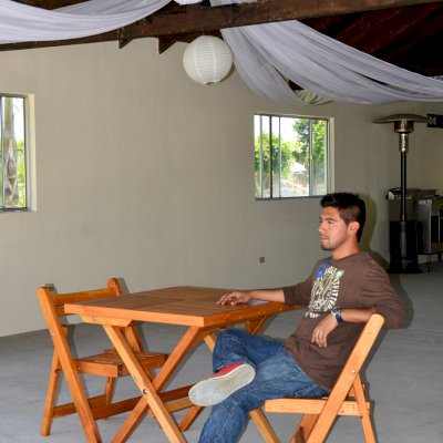 Square Wooden Folding Table (Options: 2 Folding Chairs, Douglas-fir, No Cushions, Standard Tabletop, Checkerboard Design, Rounded Corners, No Umbrella Hole, Transparent Premium Sealant). Photo Courtesy of El Laurel, Ensenada, Mexico.