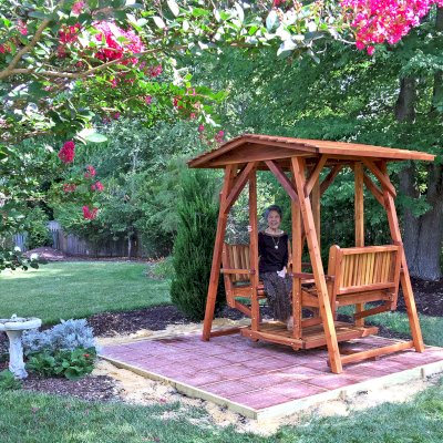 St. Anthony's Face to Face Gliders (Adult Size, California Redwood, No Beverage Armrests, No Kid's Platform, Standard Closed Roof, No Engraving, Transparent Premium Sealant). Photo Courtesy of Dulce B. of Yorktown, VA.