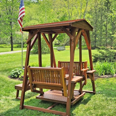 St. Anthony's Face to Face Gliders (Adult Size, Old-Growth Redwood, Standard Closed Roof, With Beverage Armrests, With Kid's Platform, No Engraving, Transparent Premium Sealant). Photo Courtesy of J. Peckham of Dorset, VT.