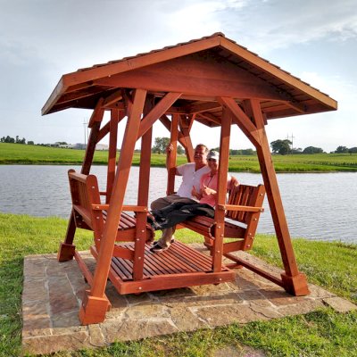 St. Anthony's Face to Face Glider (Options: Standard Roof Size, Old-Growth Redwood, Without Beverage Armrests, No Kid's Platform, Standard Closed Roof, No Engraving, Transparent Premium Sealant). Photo Courtesy of R. Vincent of Wimberly, Texas.