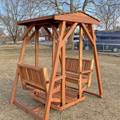 St. Anthony's Face to Face Glider (Options: Adult Glider Size, California Redwood, Without Beverage Armrests, No Kid's Platform, Standard Closed Roof, No Engraving, Transparent Premium Sealant).