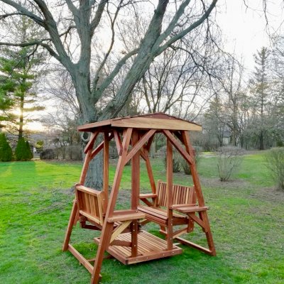 St. Anthony's Face to Face Gliders (Adult Size, California Redwood, With Beverage Armrests, No Kid's Platform, Standard Closed Roof, No Engraving, Transparent Premium Sealant). Photo Courtesy of N. Prokuski of Burr Ridge, Illinois.