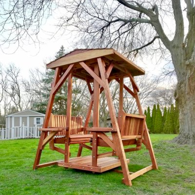 St. Anthony's Face to Face Gliders (Adult Size, California Redwood, With Beverage Armrests, No Kid's Platform, Standard Closed Roof, No Engraving, Transparent Premium Sealant). Photo Courtesy of N. Prokuski of Burr Ridge, Illinois.