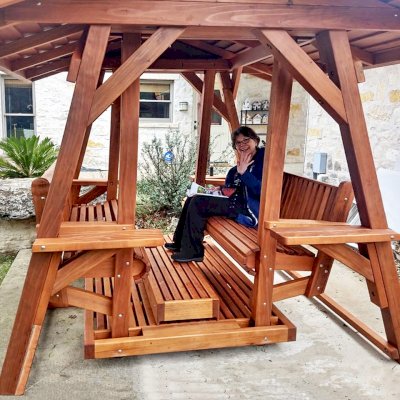 St. Anthony's Face to Face Gliders (Options: Extra Wide Size, Mature Redwood, With Beverage Armrests, No Kid's Platform,  XW Roof, No Engraving, Transparent Premium Sealant). Photo Courtesy of R. Vincent of Wimberly, Texas.