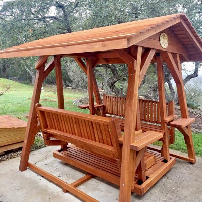 St. Anthony's Face to Face Gliders (Options: Extra Wide Size, Mature Redwood, With Beverage Armrests, No Kid's Platform,  XW Roof, No Engraving, Transparent Premium Sealant). Photo Courtesy of R. Vincent of Wimberly, Texas.