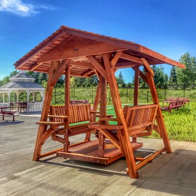 St. Anthony's Face to Face Gliders (XW, California Redwood, No Kid's Platform, XW Roof, No Engraving, Transparent Premium Sealant). Photo Courtesy of Wealshire of Medina, MN.
