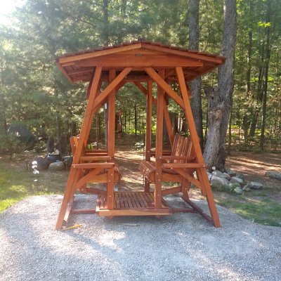 St. Anthony's Face to Face Gliders (Adult Size, California Redwood, With Beverage Armrests, No Kid's Platform, Extra Wide Roof, No Engraving, Transparent Premium Sealant). Photo Courtesy of D. Jones of Lachine, Michigan.