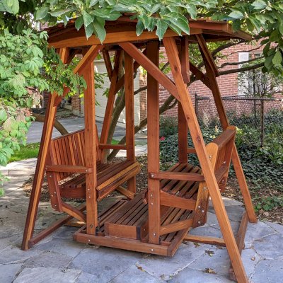St. Anthony's Face to Face Gliders (Adult Size, California Redwood, Without Beverage Armrests, With Kid's Platform, Extra Wide Roof, No Engraving, Transparent Premium Sealant). Photo Courtesy of M. Shepherd of Ontario, Canada.